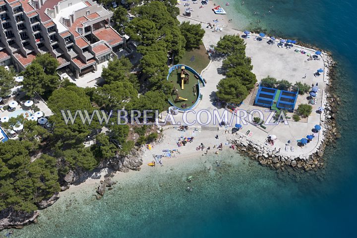 Aerial panorama of beach and children playground in front of hotel Soline