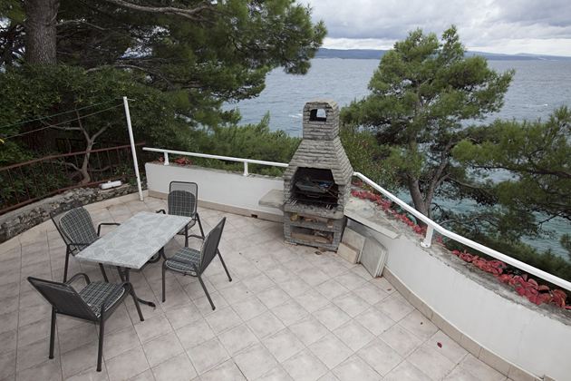 large terrace surrounded by pinetree wood with beautiful view on sea and islands